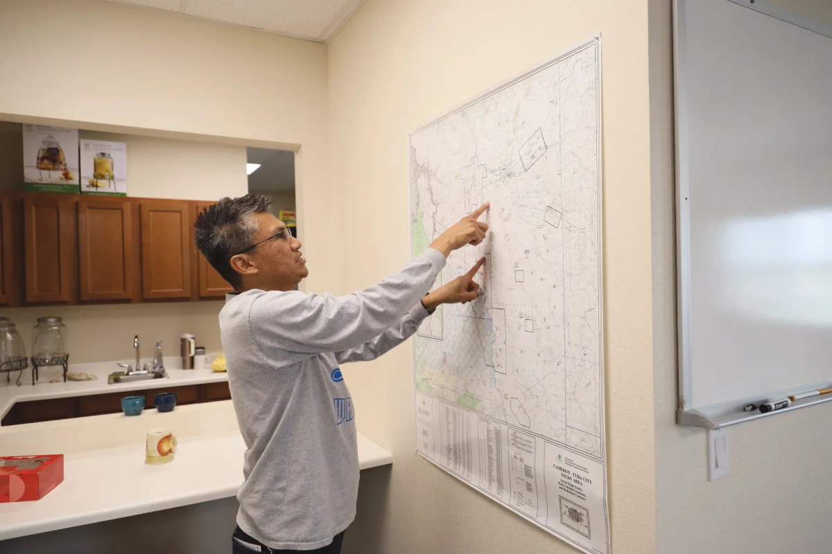 Tyrel Jones, Coalmine Canyon Chapter Community Land Use Planning Committee secretary, points toward the boundary of the chapter and the site of the proposed Painted Desert Power project, a planned solar and battery storage development on Navajo Nation land.