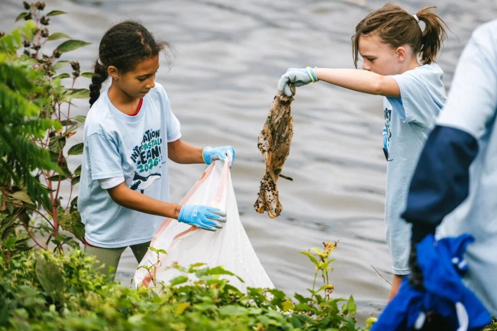 Two young children help collect trash during the 41st annual ICC.