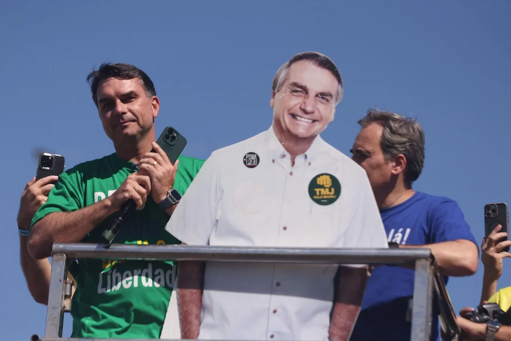 Brazilian presidential candidate Flávio Bolsonaro with a cardboard cutout of his father, former president Jair Bolsonaro
